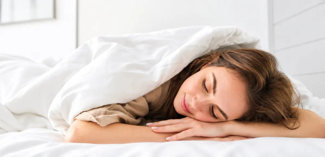 Woman sleeping on her stomach on a comfortable mattress, illustrating the ideal sleeping position for stomach sleepers.
